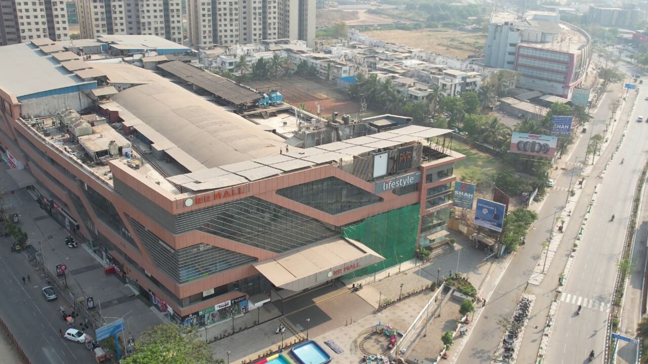 Aerial image of a multi-story Rahul Raj commercial mall rooftop fitted with solar panels