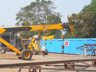 Wide shot of an Escorts Hydra 14 crane and team members at the fabrication yard