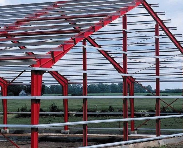Pre-Engineered Building Steel Frame The steel frame structure of a pre-engineered building (PEB) during assembly on a construction site.