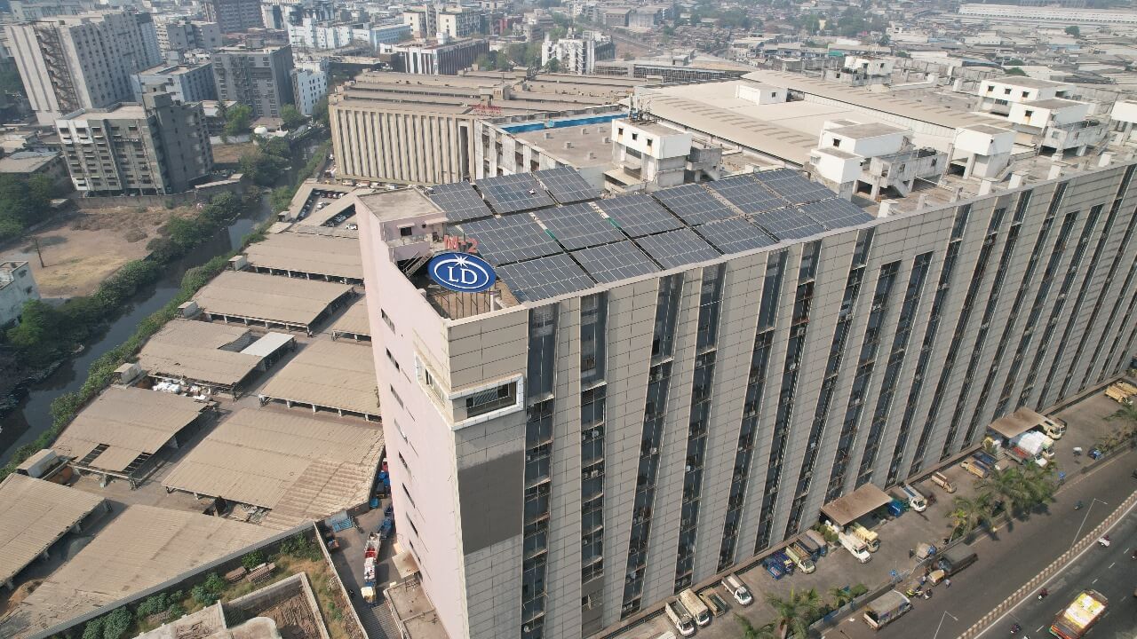 Solar panels installed on the top floor of a high-rise Millennium Market office building in an urban district