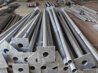 A collection of finished galvanized steel structures at a manufacturing plant.