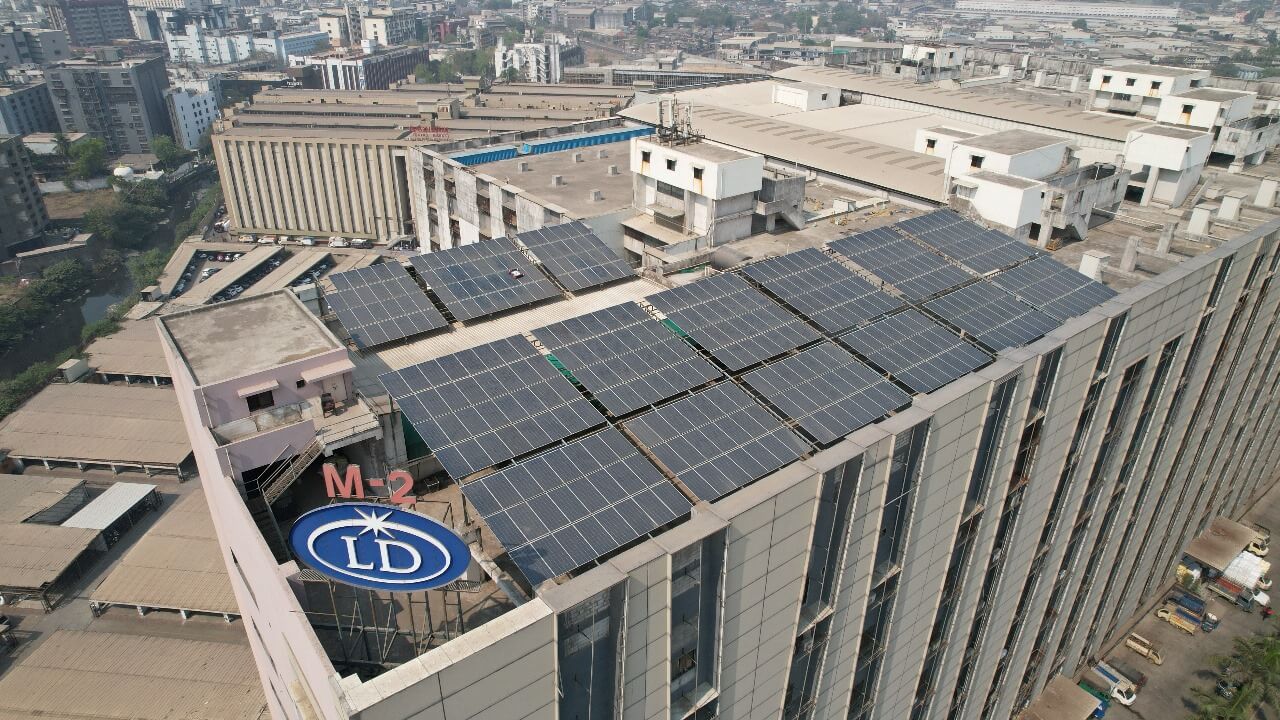Rooftop solar panel arrays on an Millennium Market office with corporate logo visible